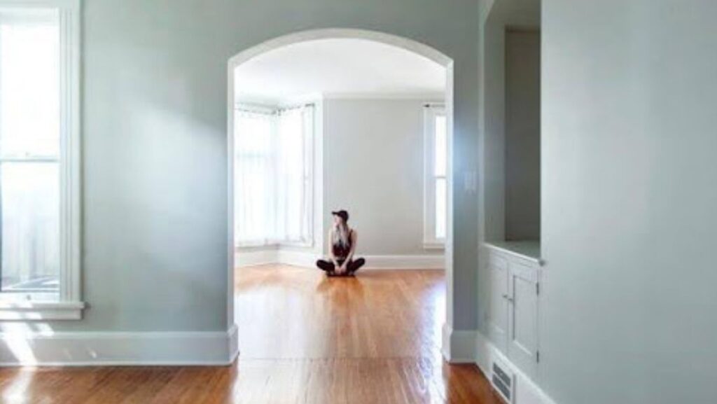 Person sitting in an empty home