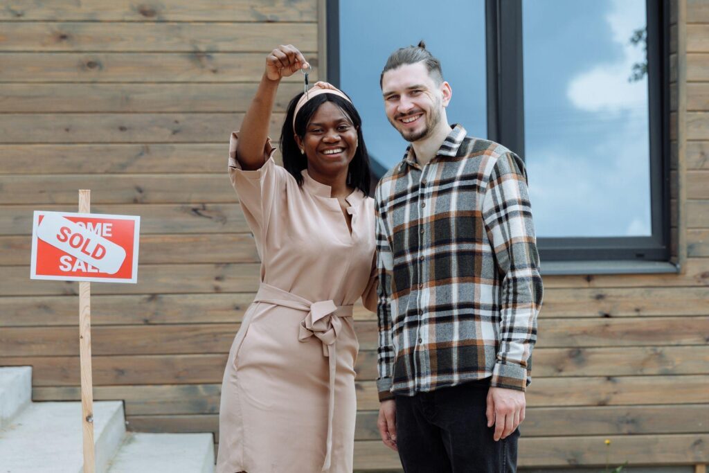 a couple standing in front of a new home